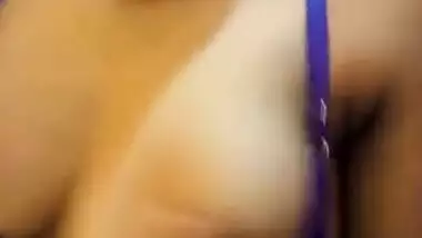 Wife in a blue sex bra takes a XXX Indian tit out and squeezes it