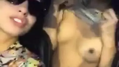 Two hot babes flash there boobs and kiss each other in moving ca